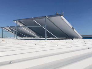 Solar hot water panels fitted to a metal roof in Brisbane