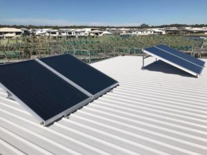 Solar hot water system panels installed on a metal roof in Brisbane