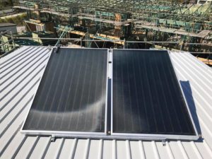 Solar hot water panels mounted on a metal roof in Brisbane, forming part of an energy-efficient hot water system