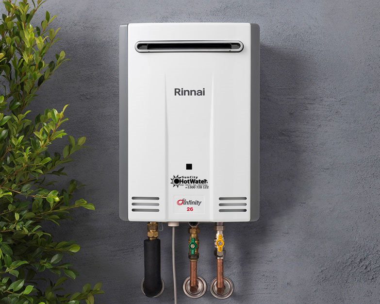 Wall-mounted instantaneous gas hot water unit fixed to grey render, ideal for Brisbane homes.